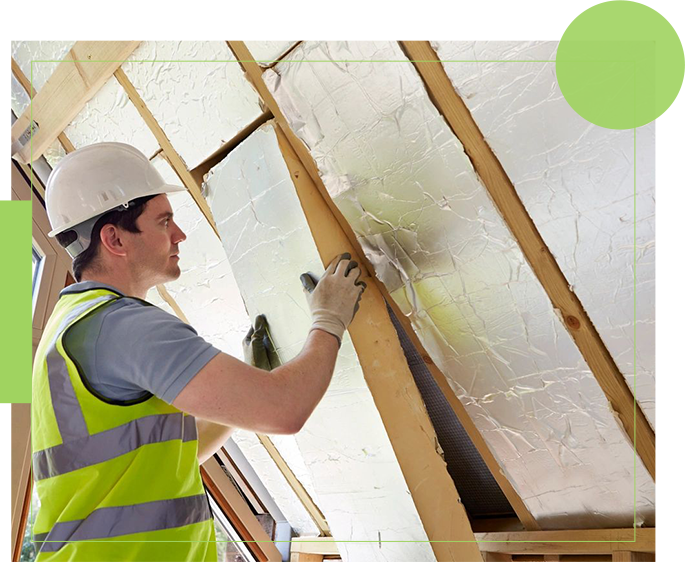 A man in safety gear working on the ceiling of a house.