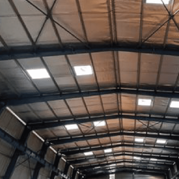 A large warehouse with many lights on the ceiling.