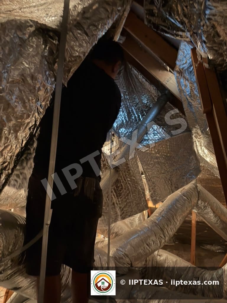 IIP Texas crew installing double bubble foil radiant barrier on attic rafters in the Dallas-Fort Worth area
