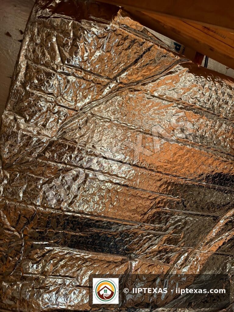 IIP Texas crew installing double bubble foil radiant barrier on attic rafters in the Dallas-Fort Worth area