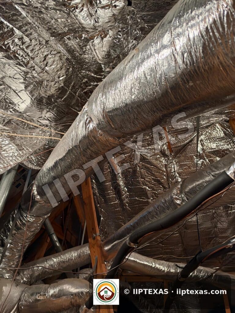 IIP Texas crew installing double bubble foil radiant barrier on attic rafters in the Dallas-Fort Worth area