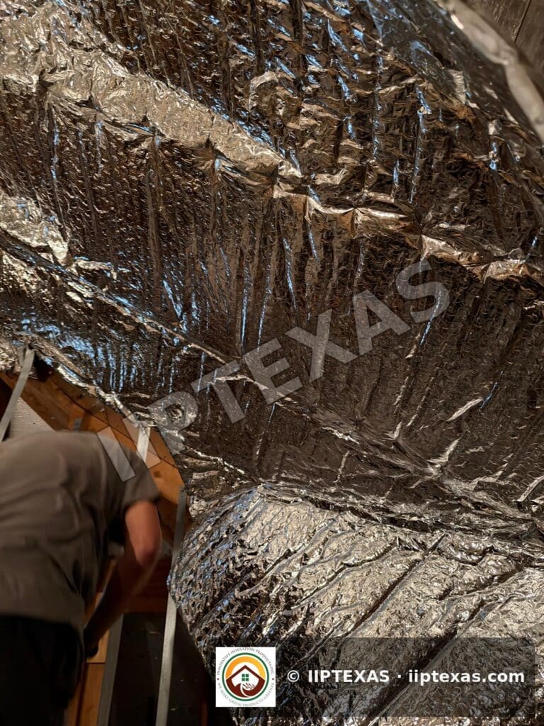 IIP Texas crew installing double bubble foil radiant barrier on attic rafters in the Dallas-Fort Worth area
