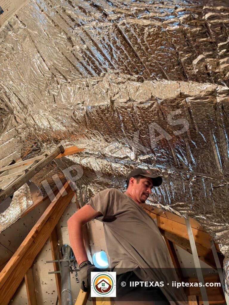 IIP Texas crew installing double bubble foil radiant barrier on attic rafters in the Dallas-Fort Worth area