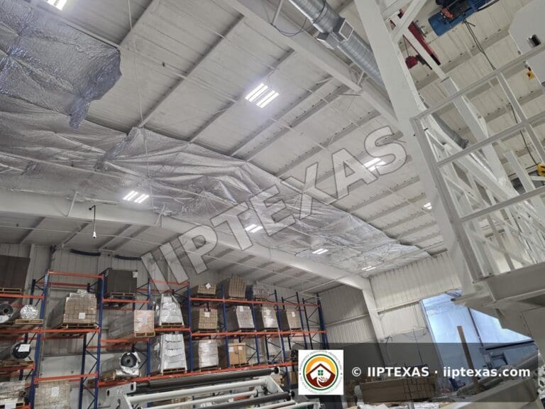 IIP Texas crew installing reflective bubble foil insulation under the roof of a metal building