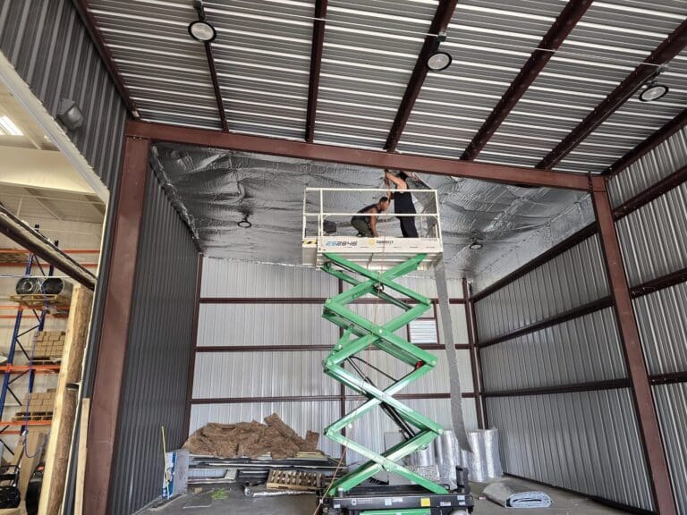Crew installing IIP insulation on a building ceiling