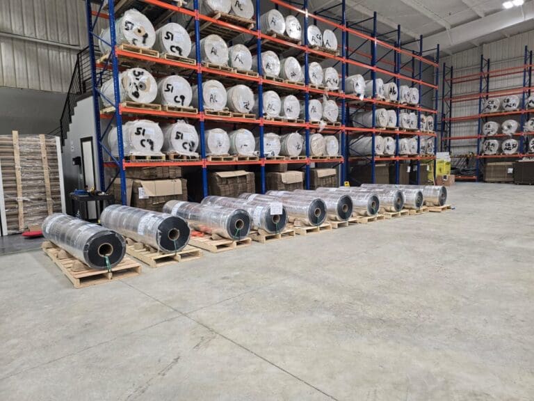 Warehouse racks stacked with rolls at the IIP Rhome plant